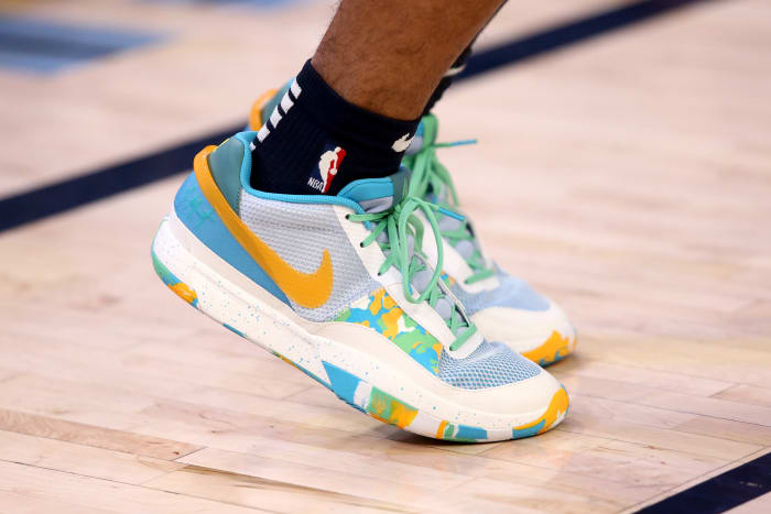 View of Ja Morant's blue and yellow Nike shoes.